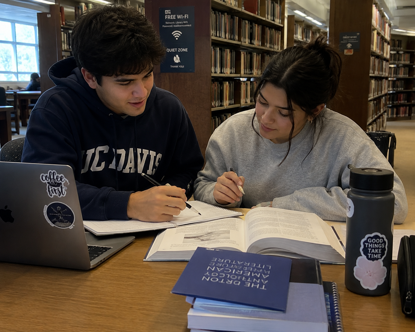 Two students studying together in the library